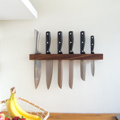 walnut knife holder with knives in kitchen