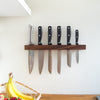 walnut knife holder with knives in kitchen